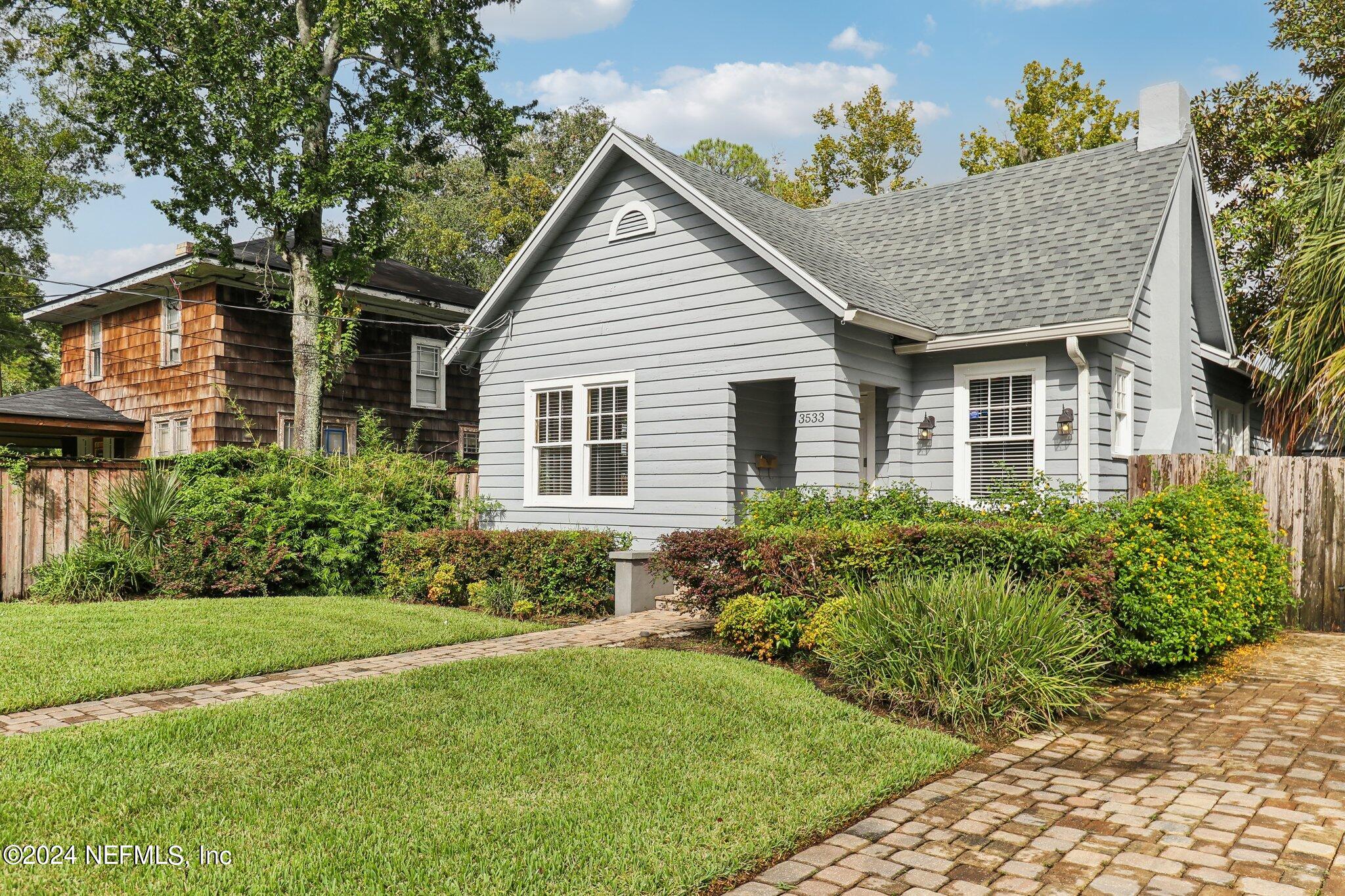 a front view of a house with garden