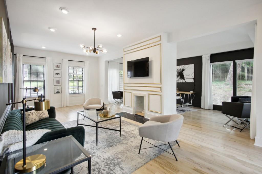 a living room with furniture a fireplace and a flat screen tv