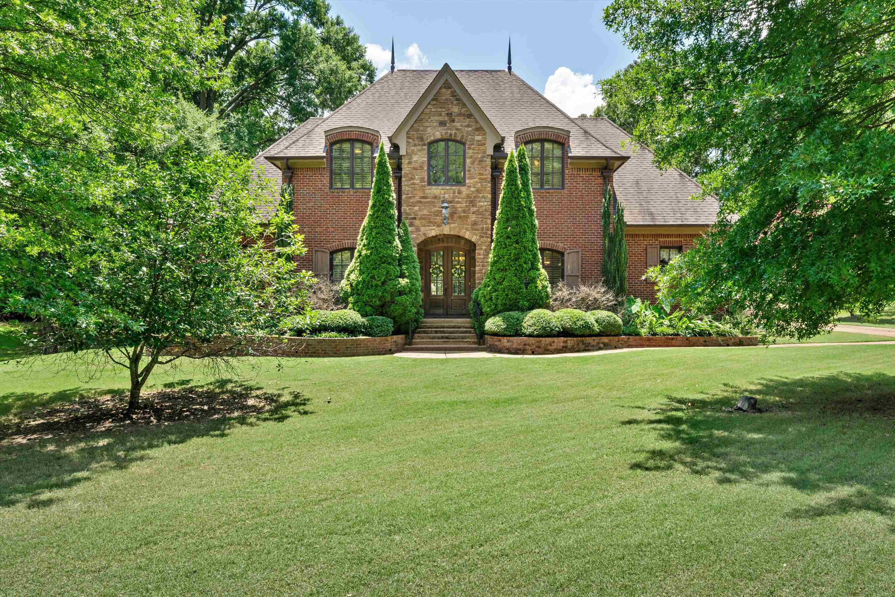 a front view of a house with a yard