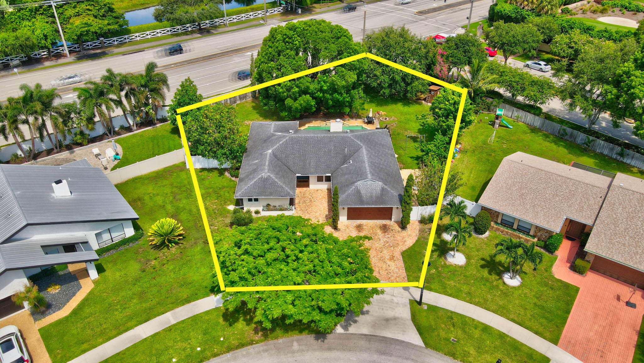 an aerial view of a house with a garden and swimming pool