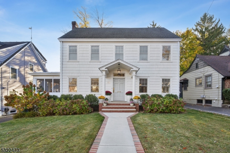 a front view of a house with a garden