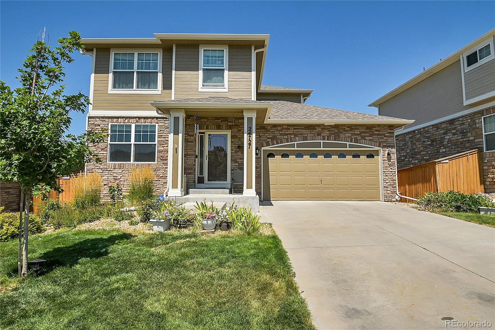 a front view of a house with a yard and garage