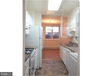 a kitchen with stainless steel appliances granite countertop a stove and a refrigerator