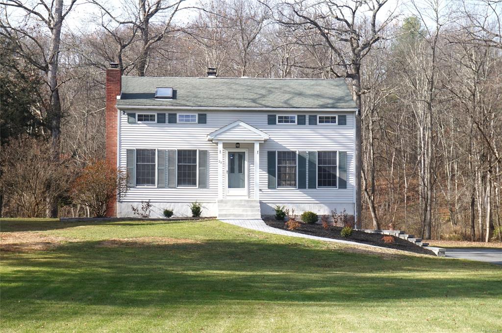 Colonial-style house with a front lawn