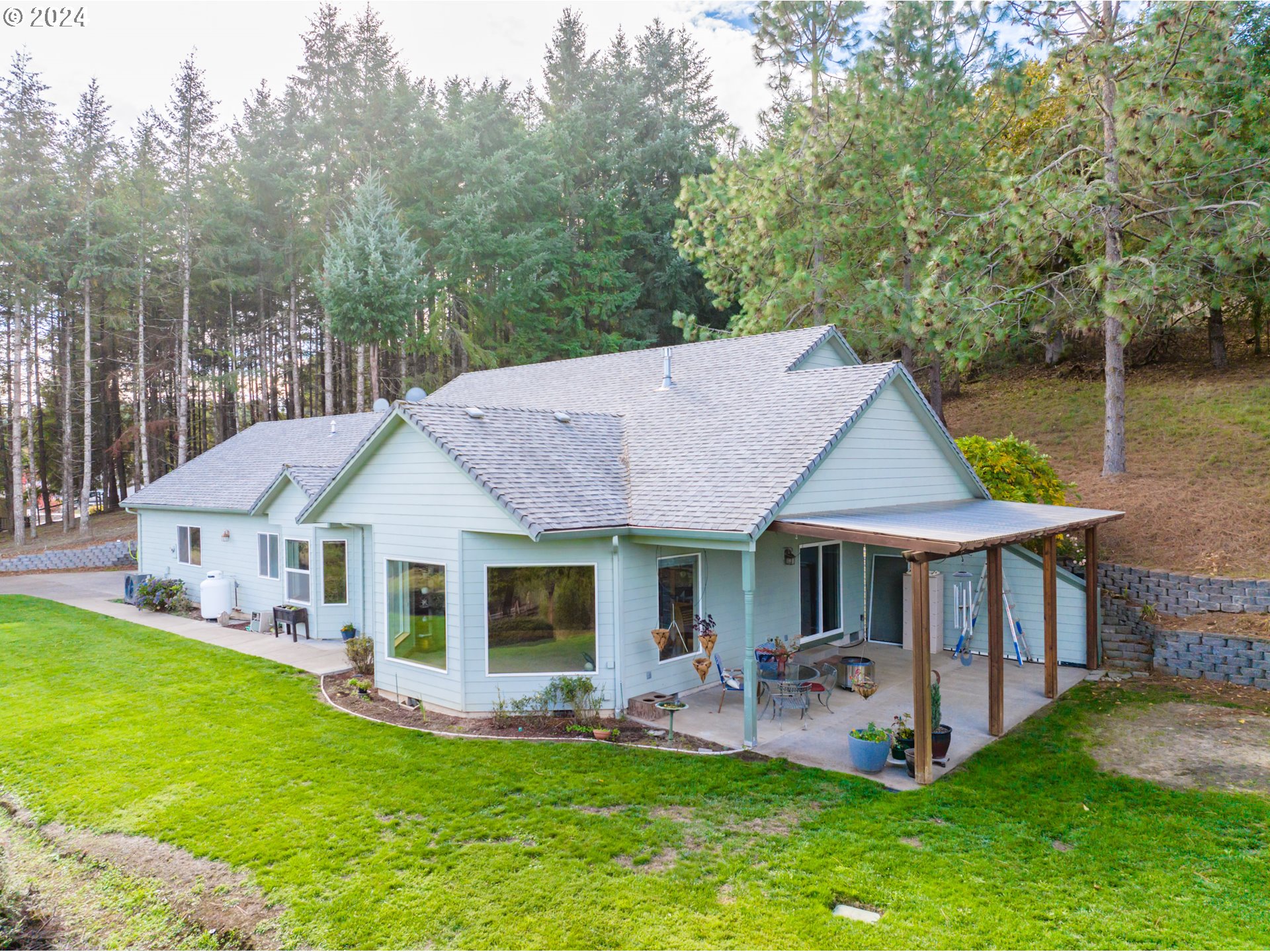 a front view of a house with a yard deck and patio