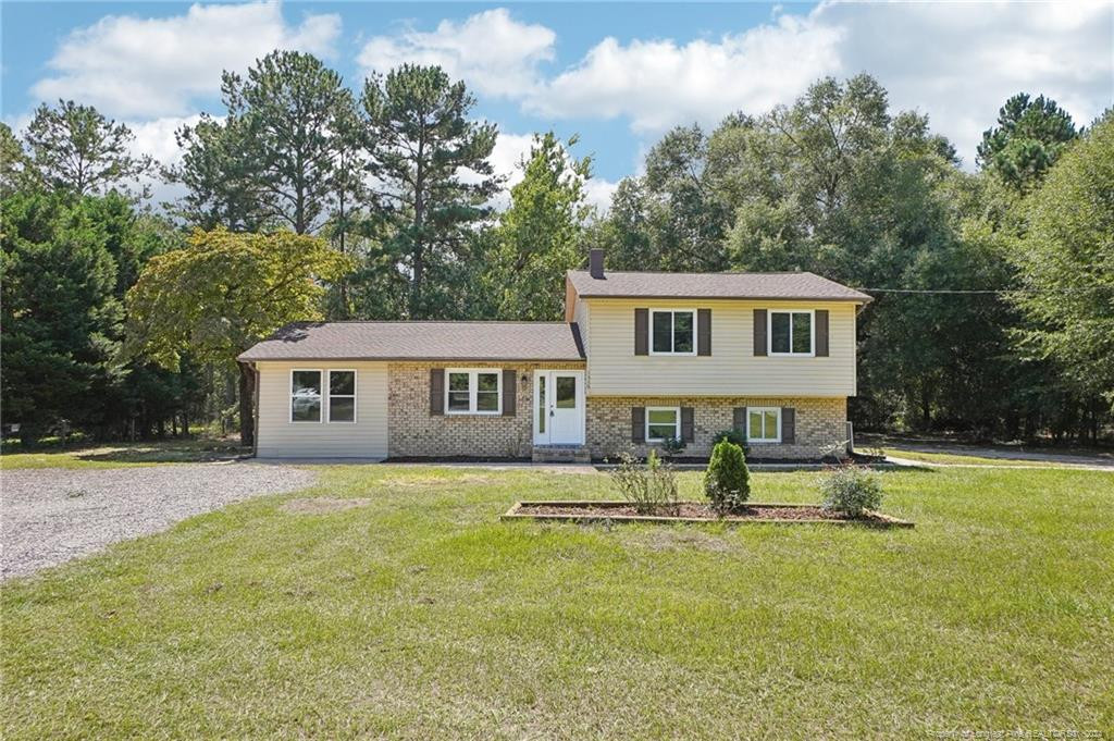 a house that has a big yard and large trees