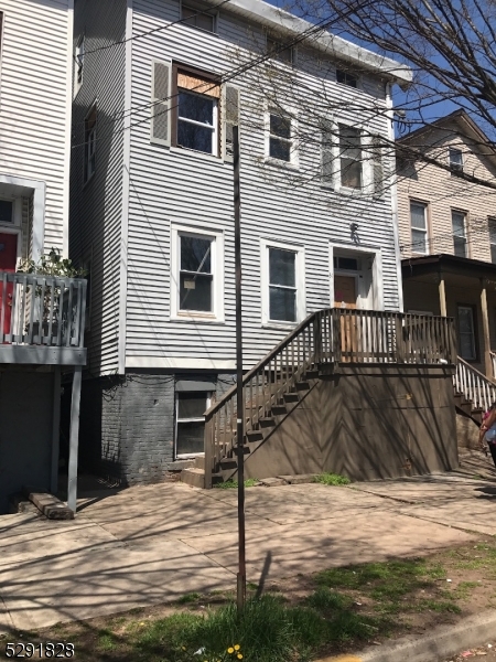 a view of a house with a wooden fence