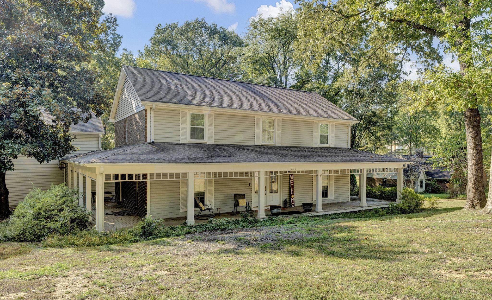 Farmhouse-style home featuring a porch and a front lawn