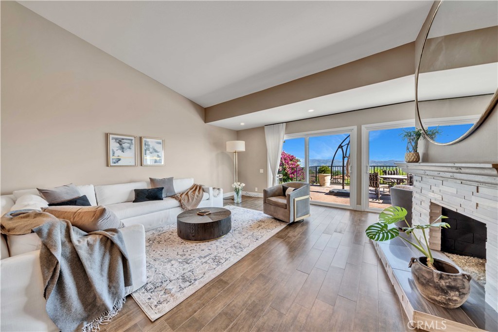 a living room with fireplace furniture and a wooden floor