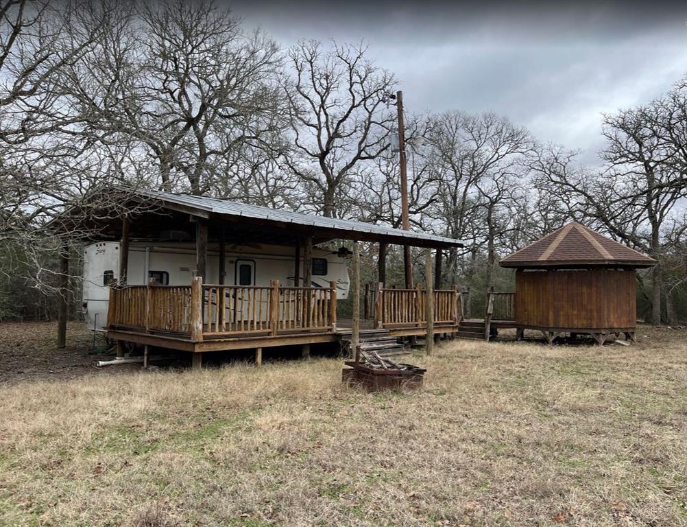 a backyard of a house with yard and barbeque oven