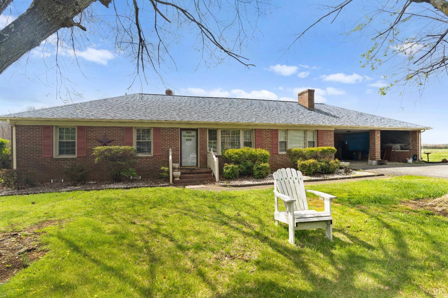 a front view of a house with swimming pool and porch with furniture