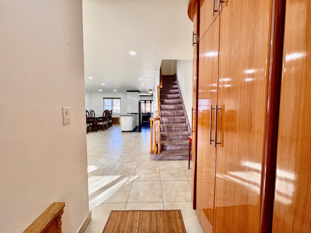 Corridor with light tile patterned flooring