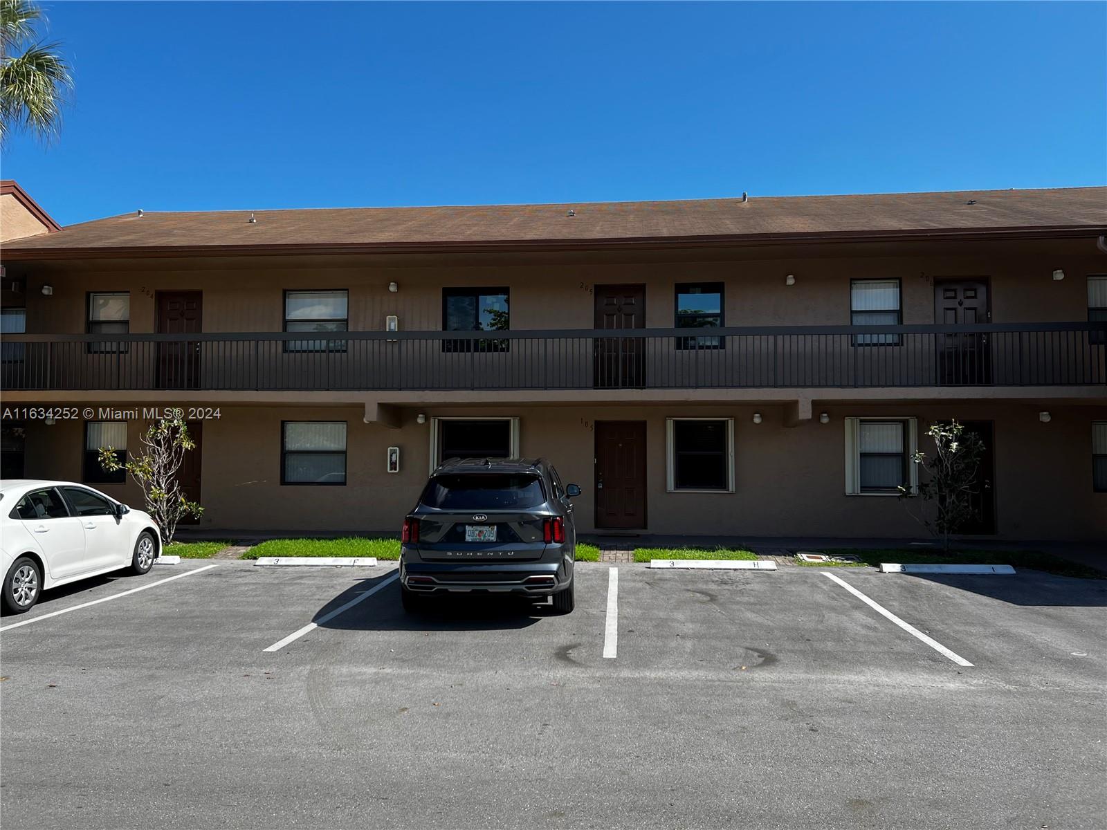 a view of a car park in front of house