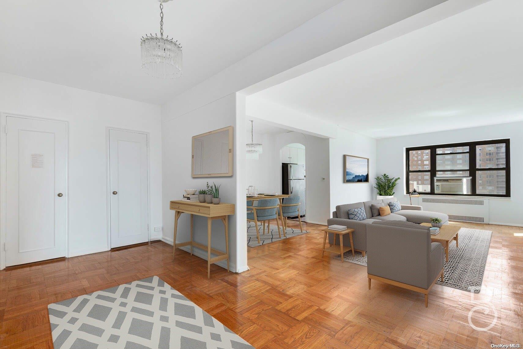 a living room with furniture and a kitchen