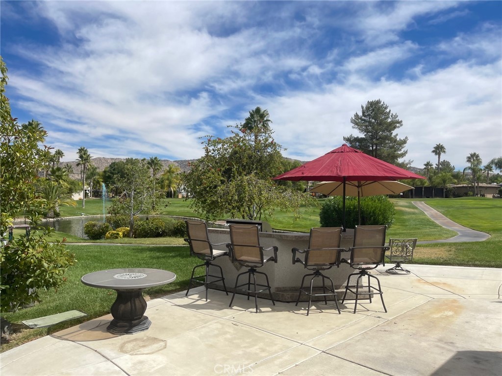 a view of a table and chairs under an umbrella