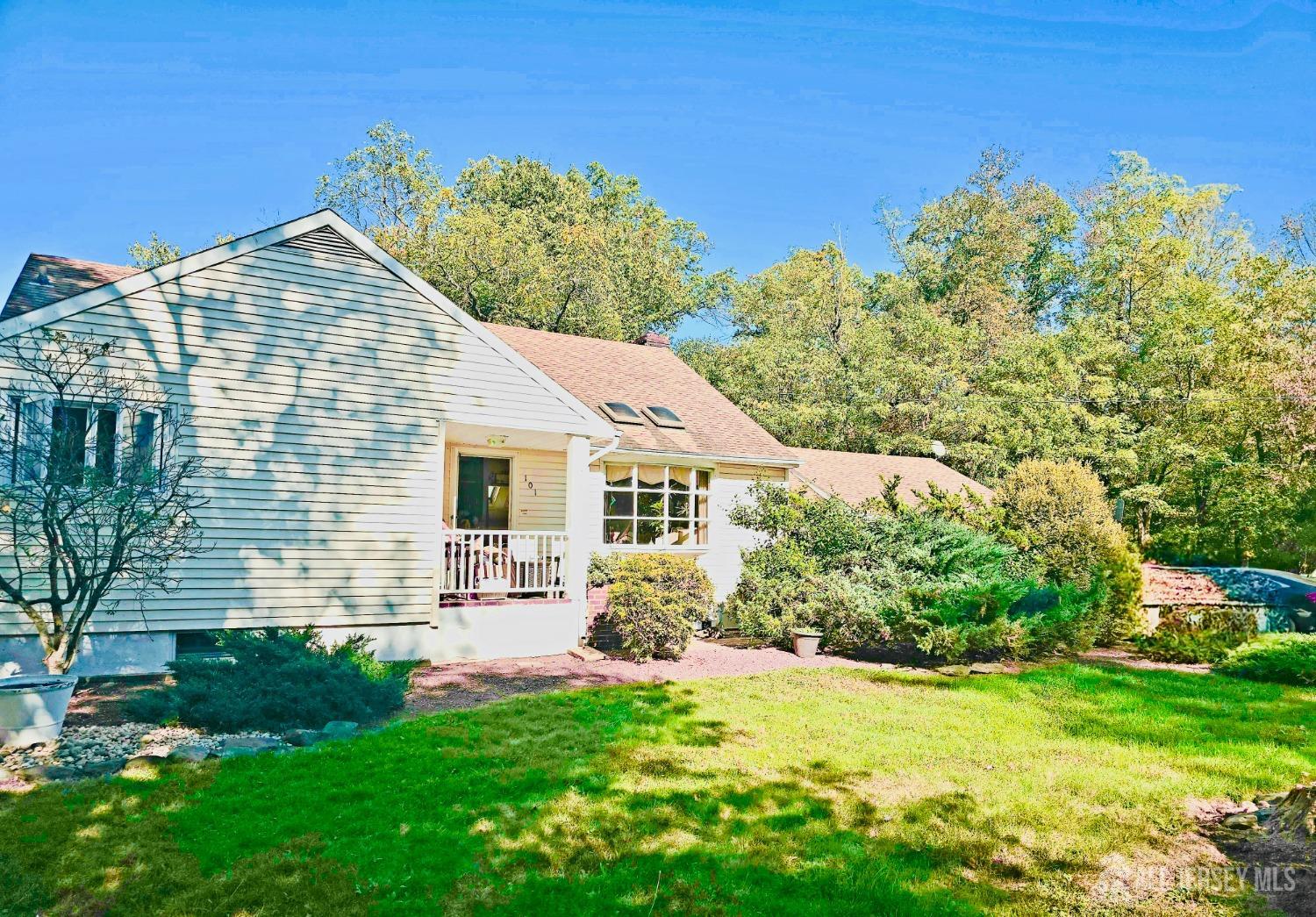 a view of a house with a yard and potted plants