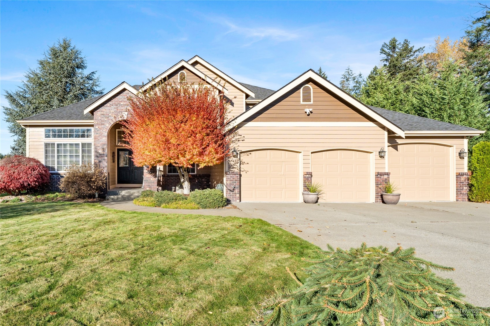 a view of a house with a yard and garage