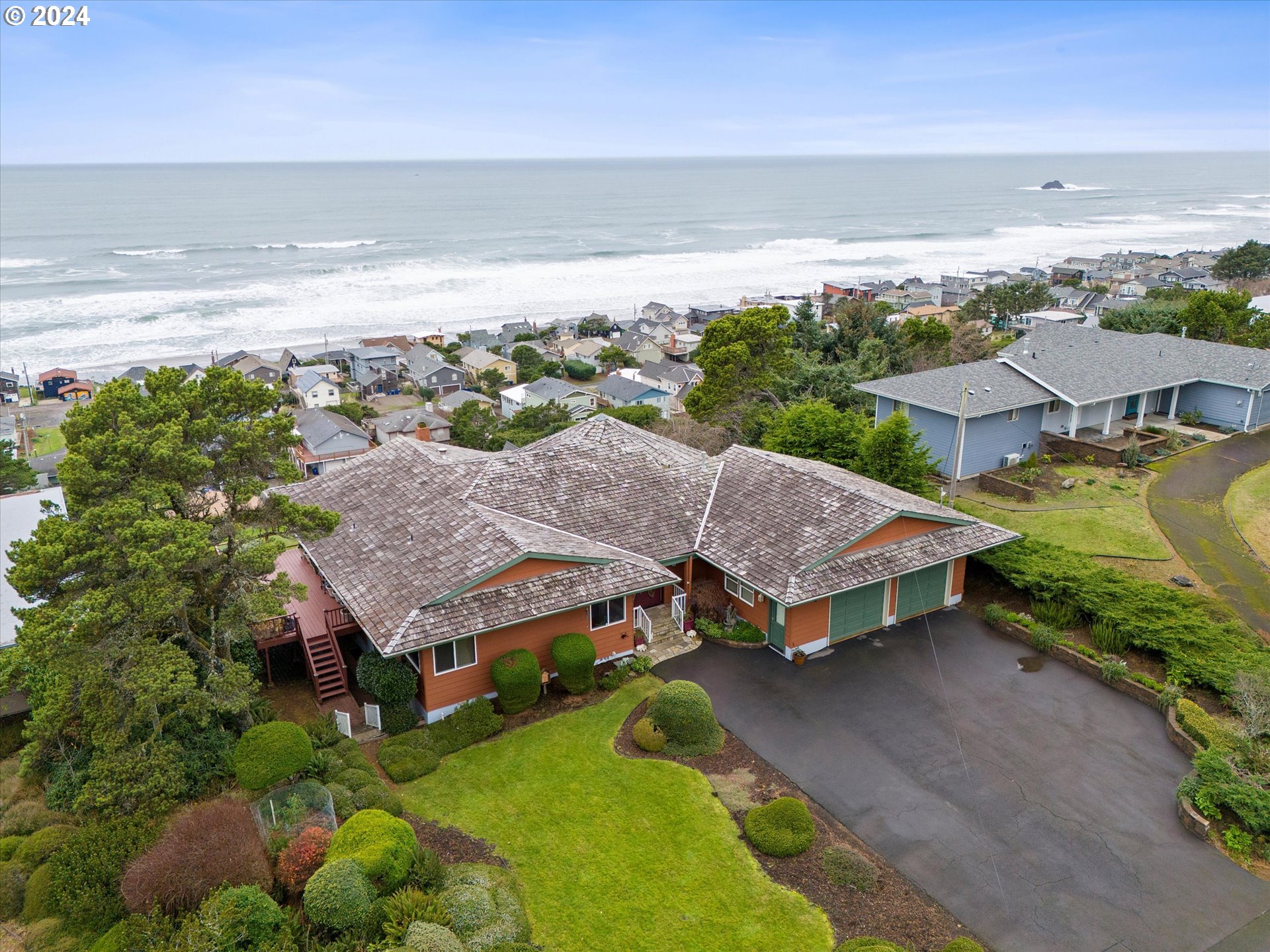 a aerial view of a house with a garden and lake view