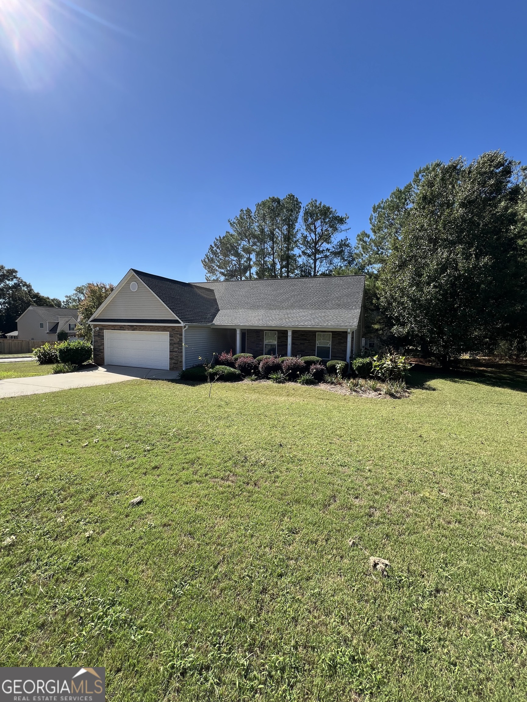 a front view of a house with yard and green space