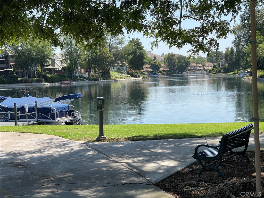 a view of a lake with a bench and trees