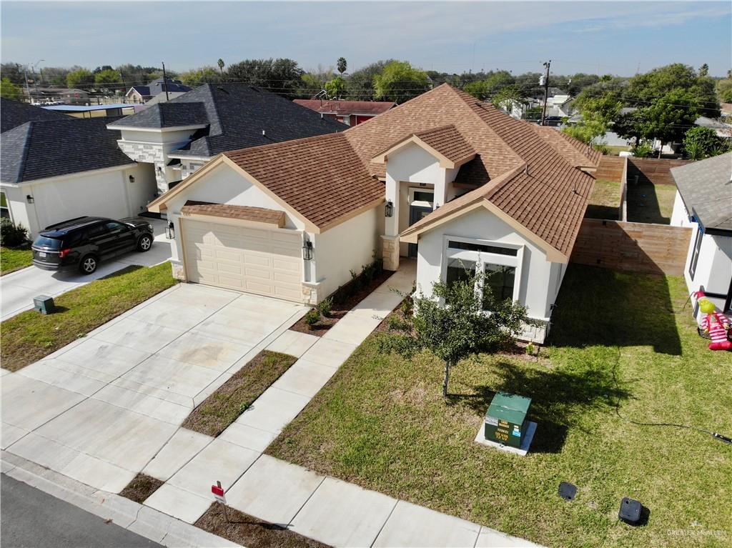 an aerial view of a house with a yard