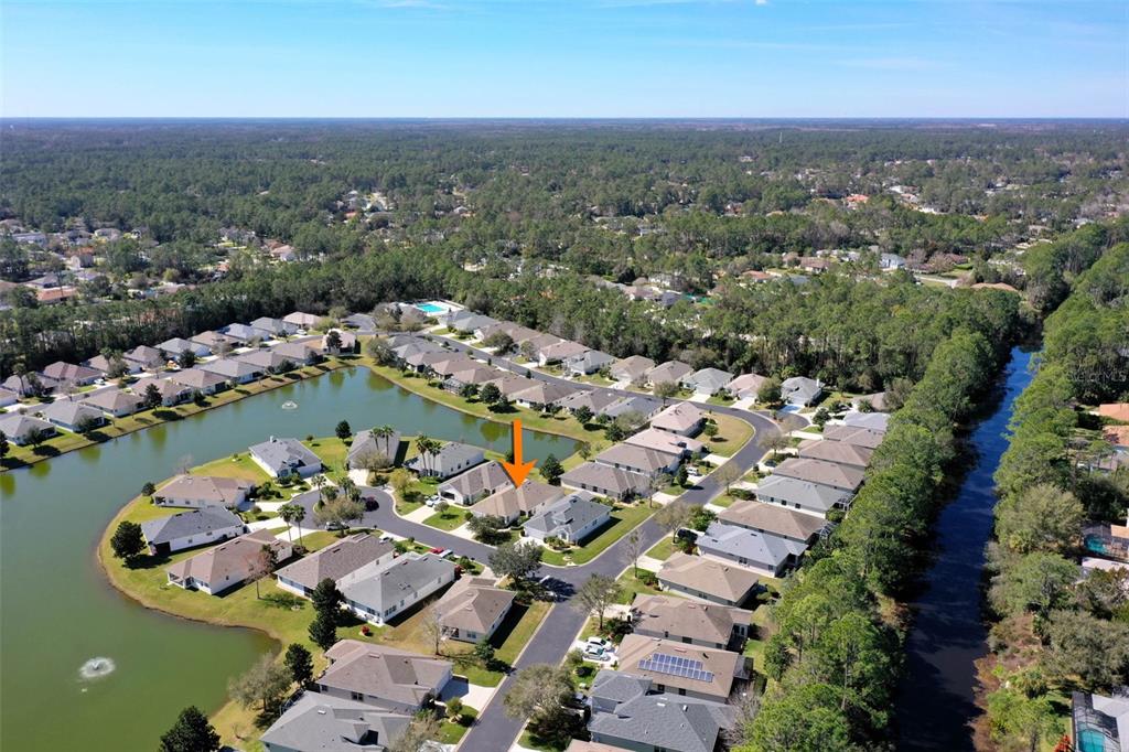 an aerial view of a houses with a swimming pool