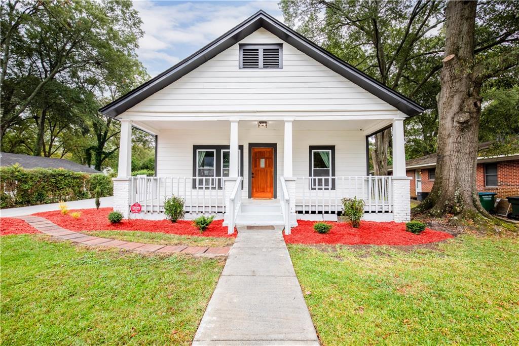 a front view of house with yard and seating space