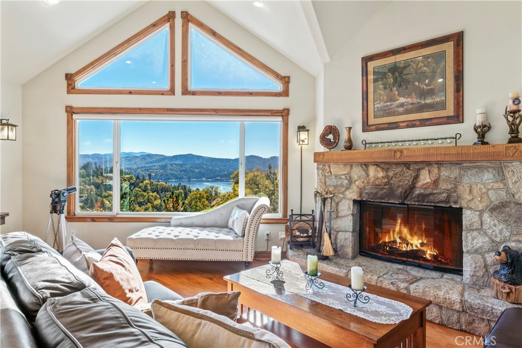 a living room with furniture a fireplace and a large window