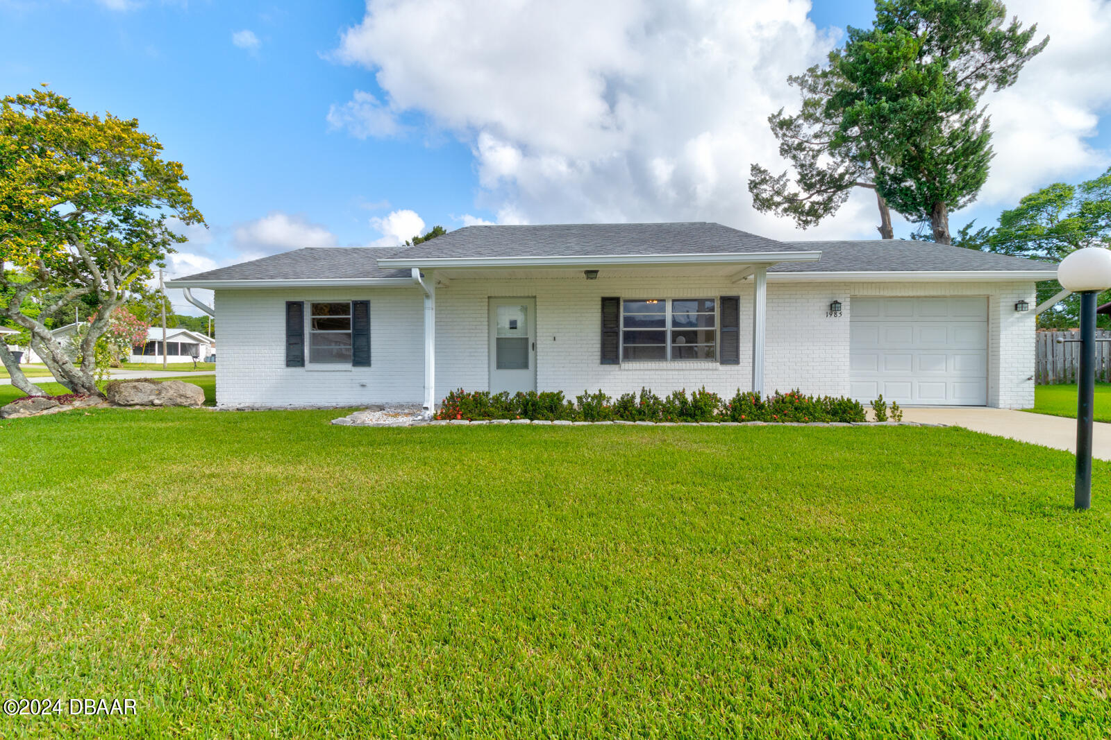 a front view of house with yard and green space