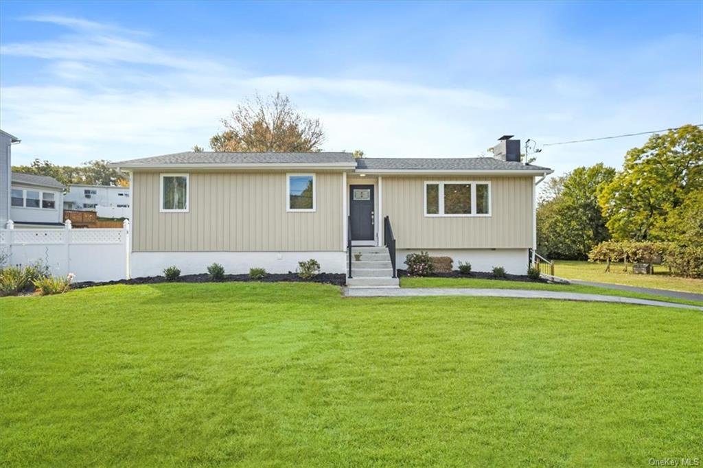 a front view of house with yard and green space