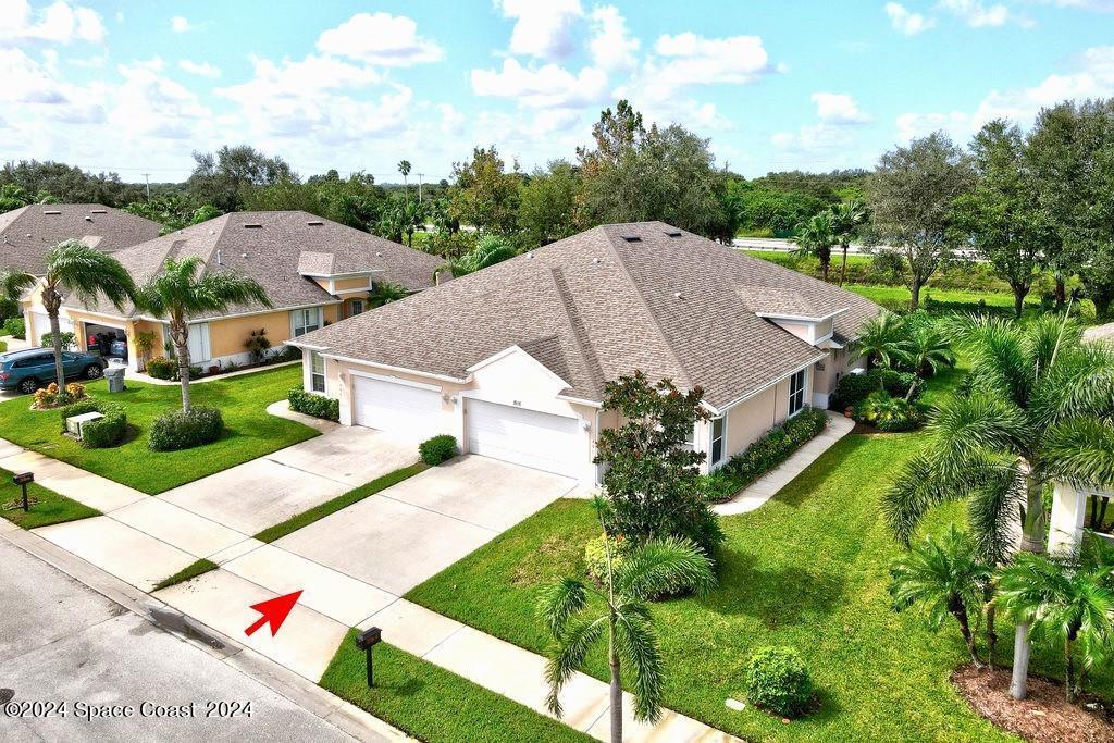 a aerial view of a house with a yard and plants