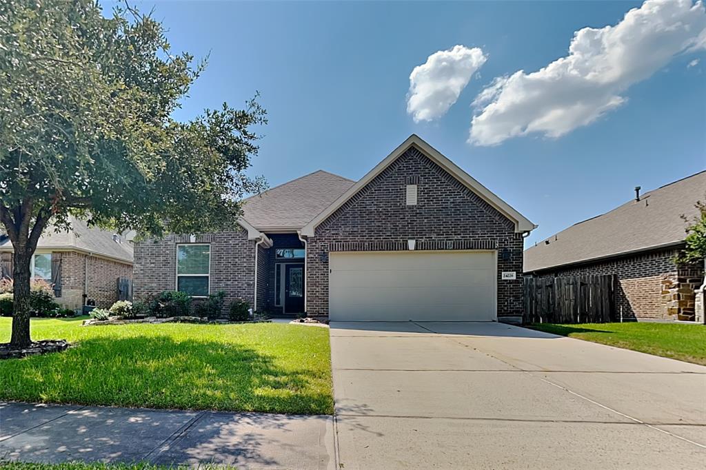 a front view of a house with a yard and garage