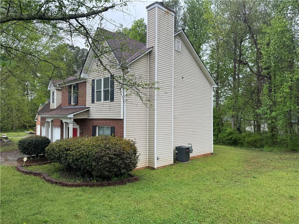 a view of backyard of house with green space