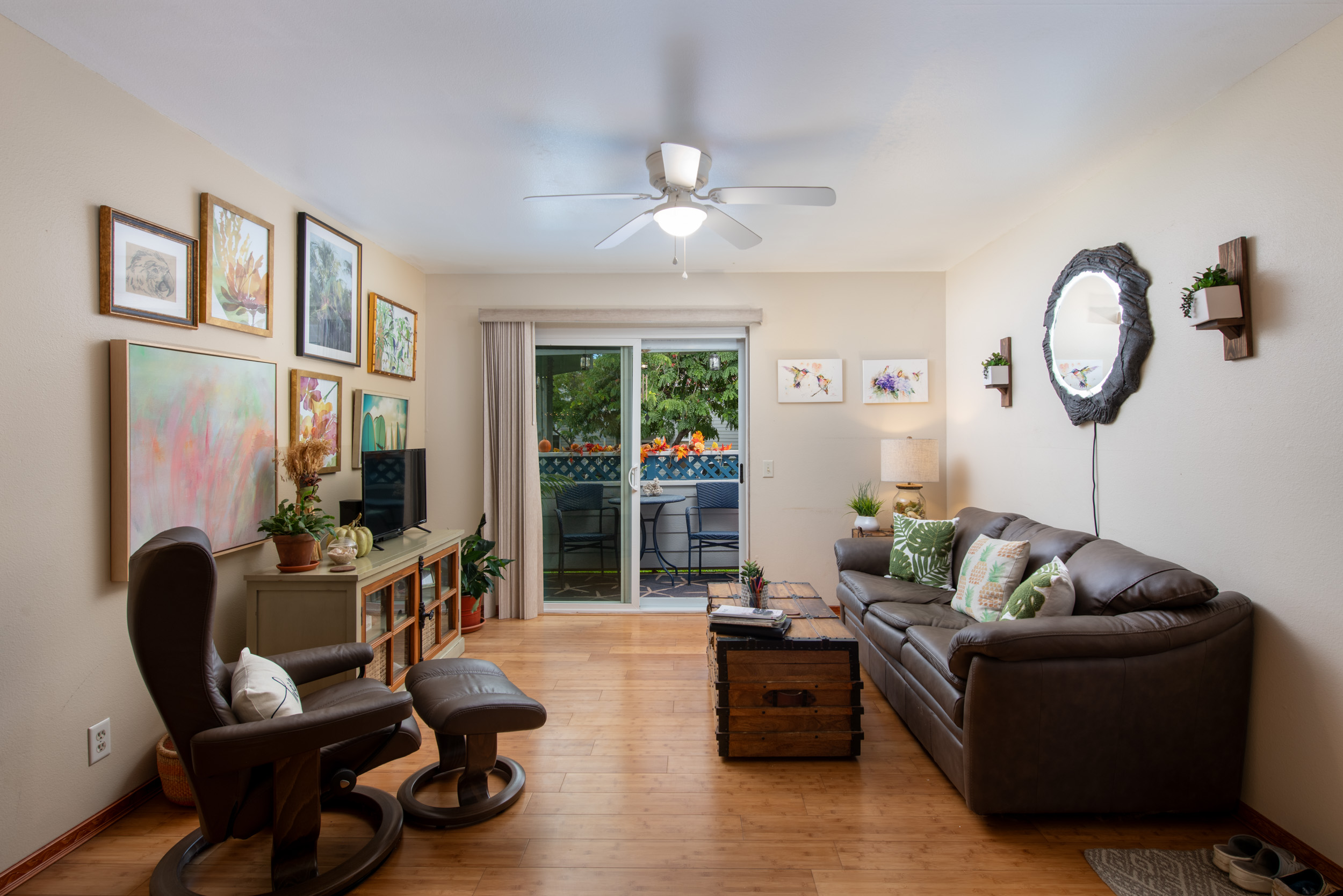 a living room with furniture a fireplace and a large window