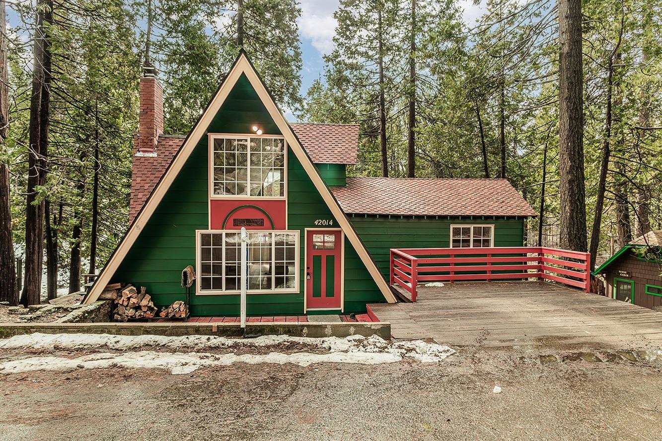 a view of a small house in middle of the forest