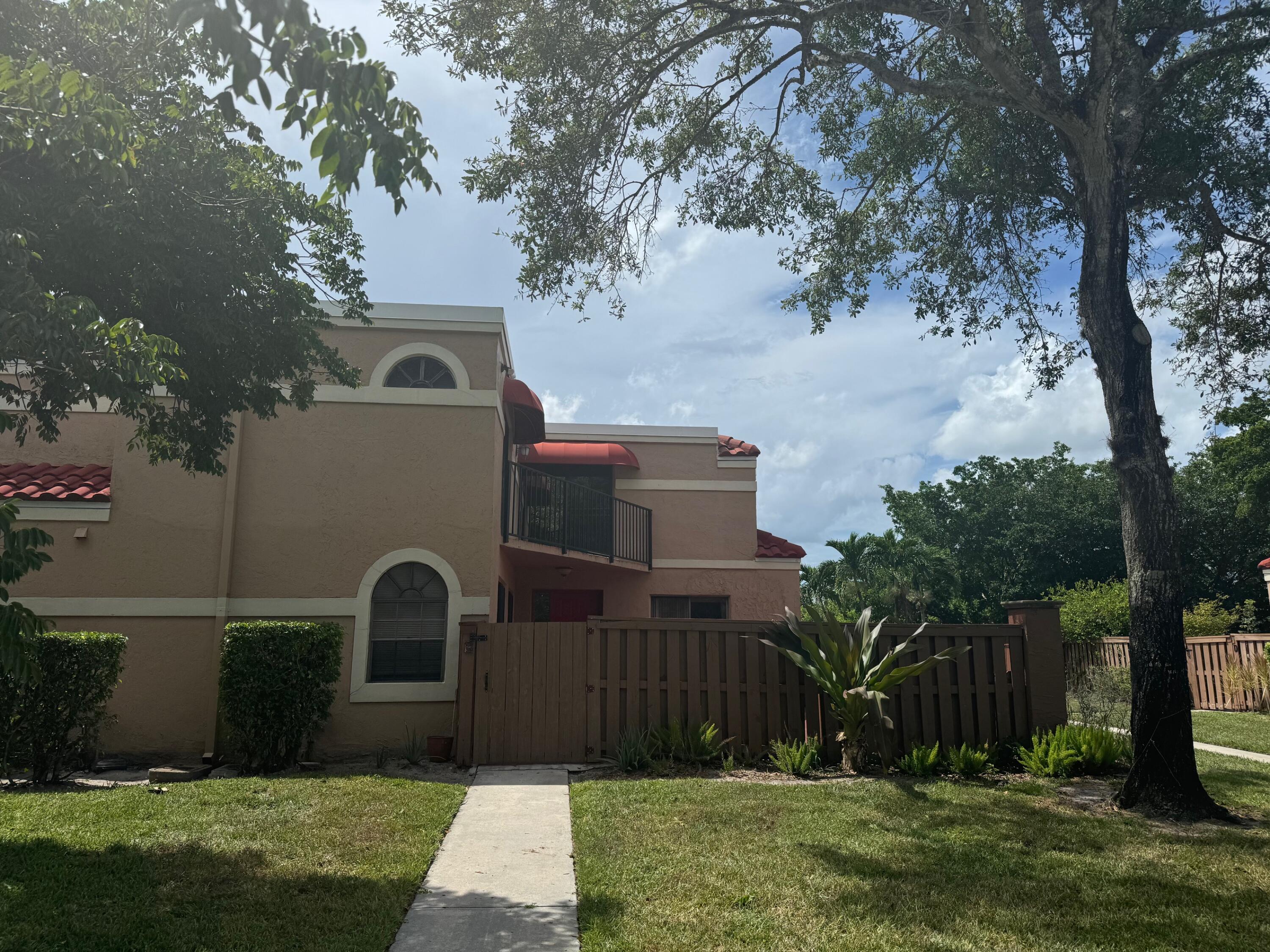 a front view of house with yard and trees