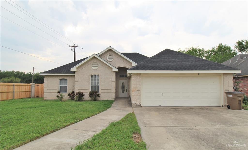 a view of a house with a yard and garage