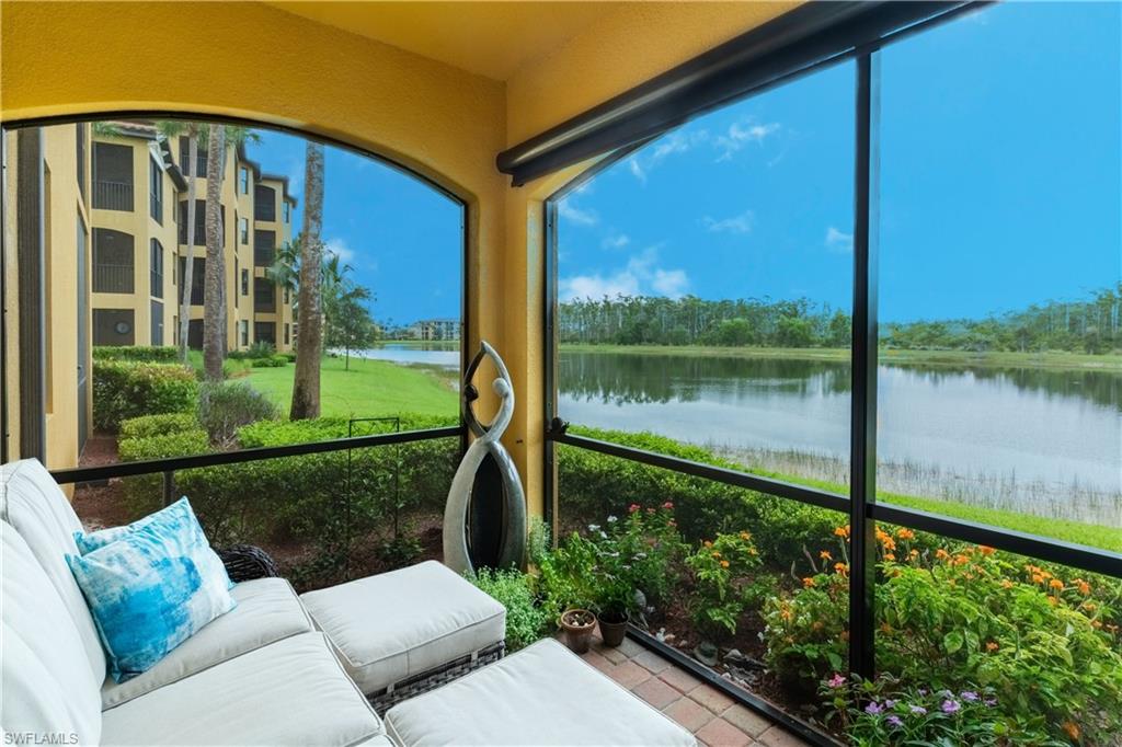 Sunroom featuring a water view