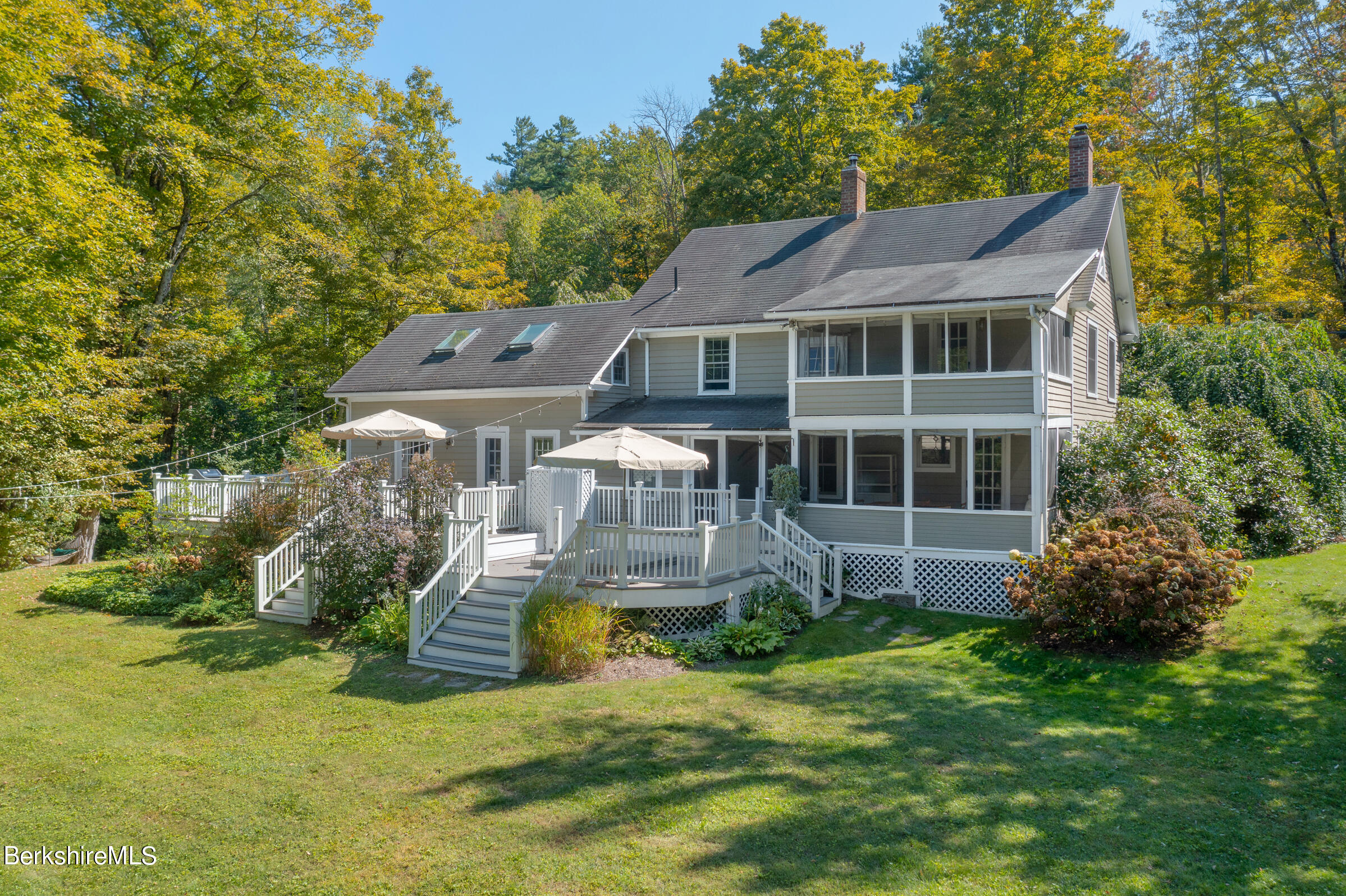 a front view of a house with a yard table and chairs