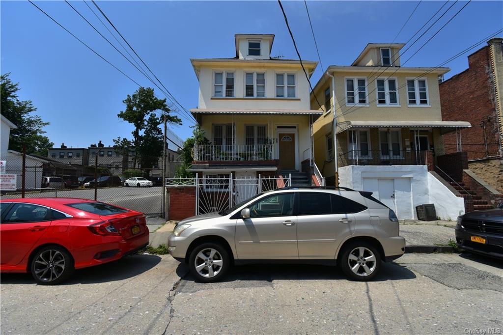 a front view of a house with parking space