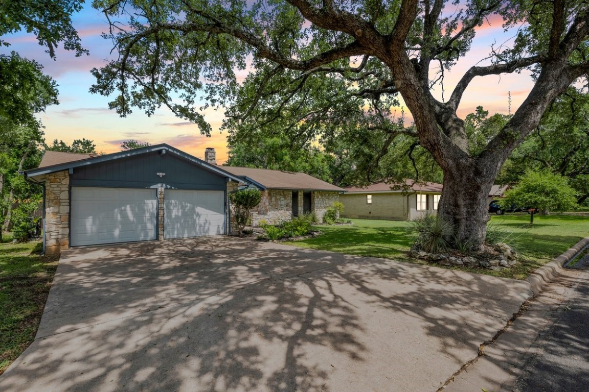 a view of a house with a tree in front of it