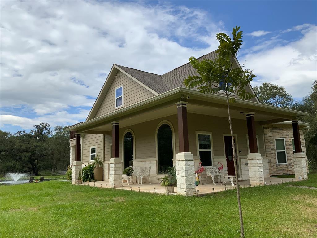 a front view of a house with a garden and plants