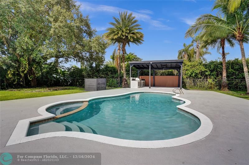 a view of a swimming pool with a patio