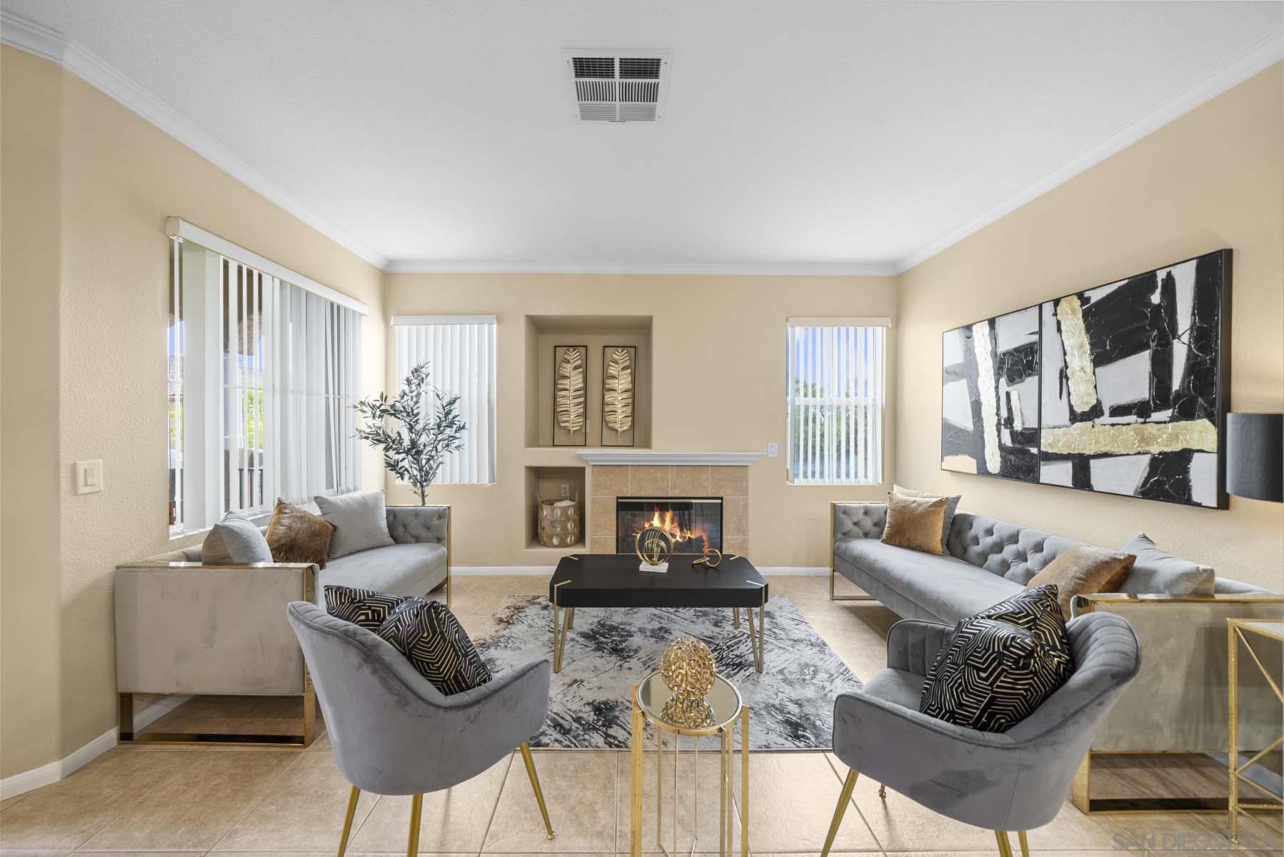 a living room with furniture a fireplace and a window