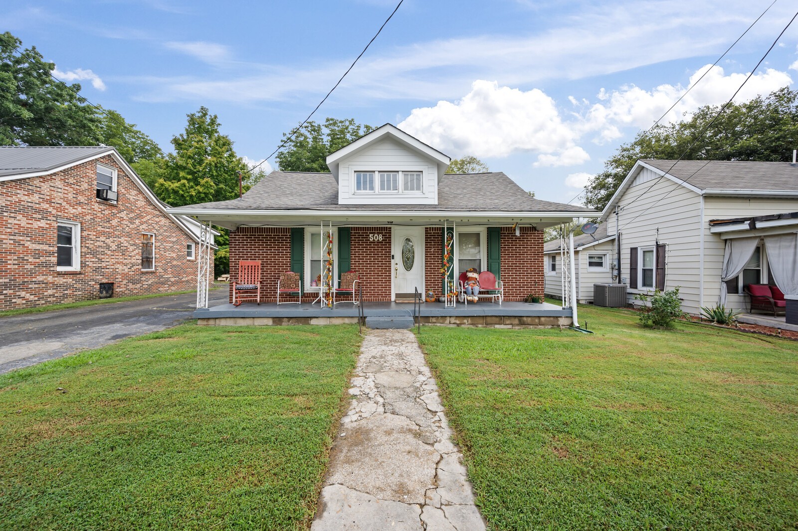 a front view of a house with a yard table and chairs