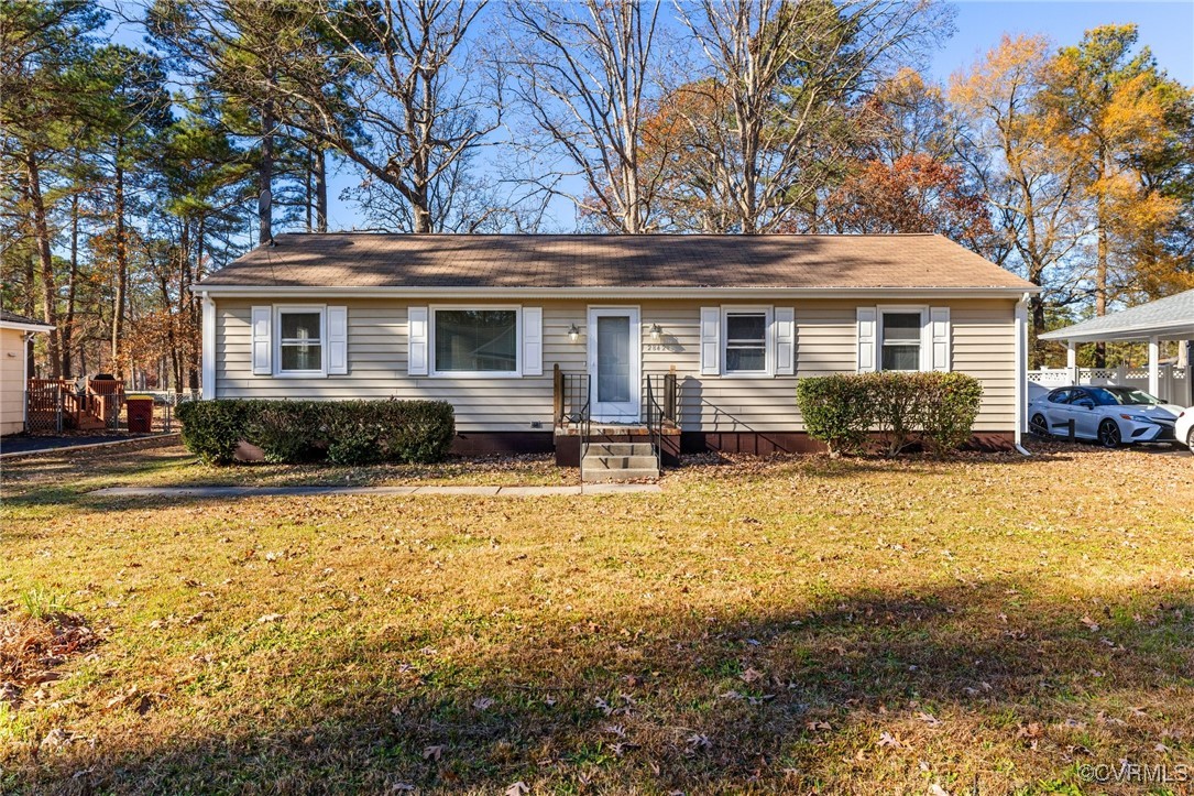 a front view of a house with yard and trees