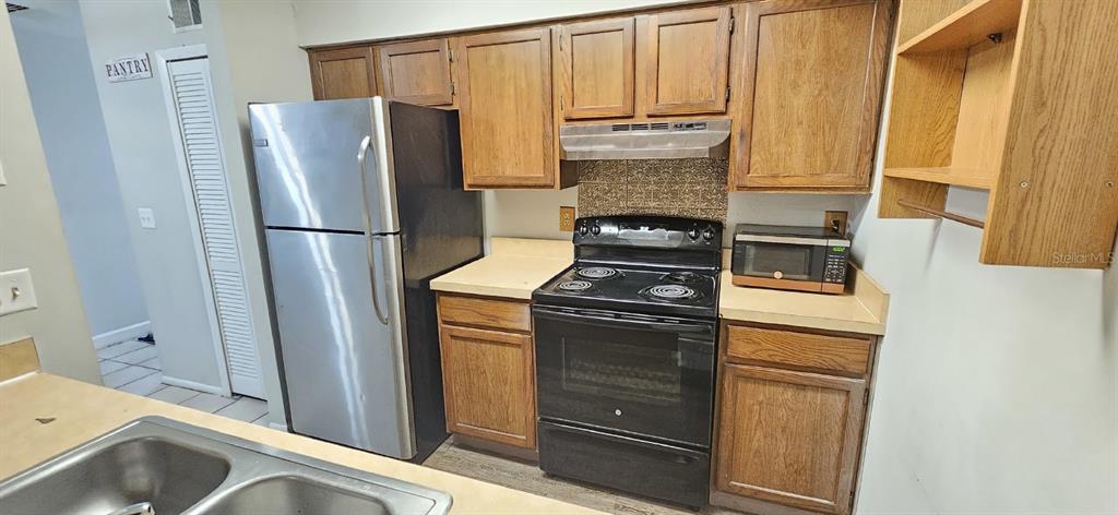 a kitchen with stainless steel appliances a refrigerator and a stove