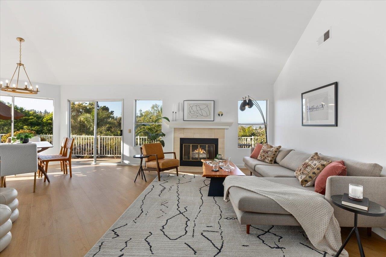 a living room with furniture large window and a fireplace