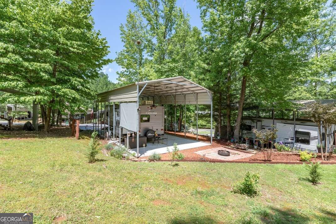 a view of a house with backyard and sitting area