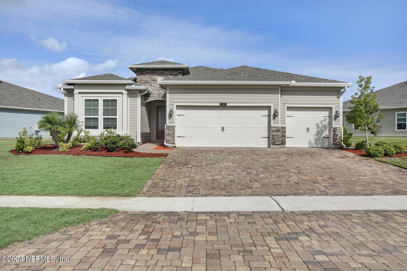 a front view of a house with garden